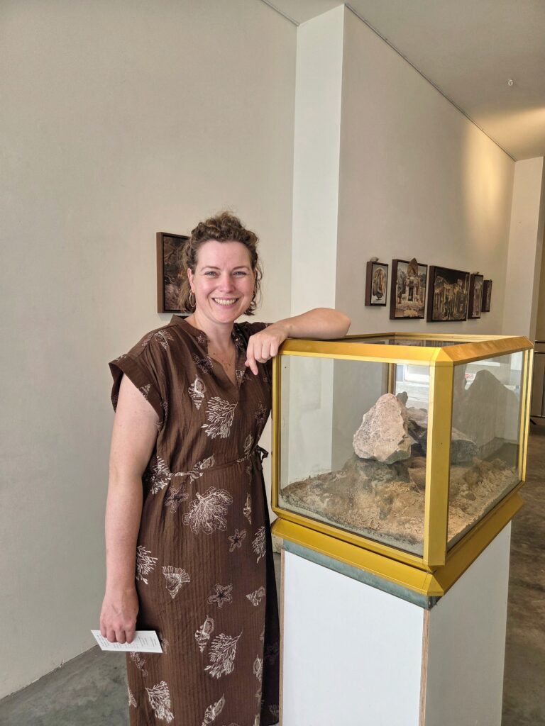 artist Sanne van Gent standing next to one of her works